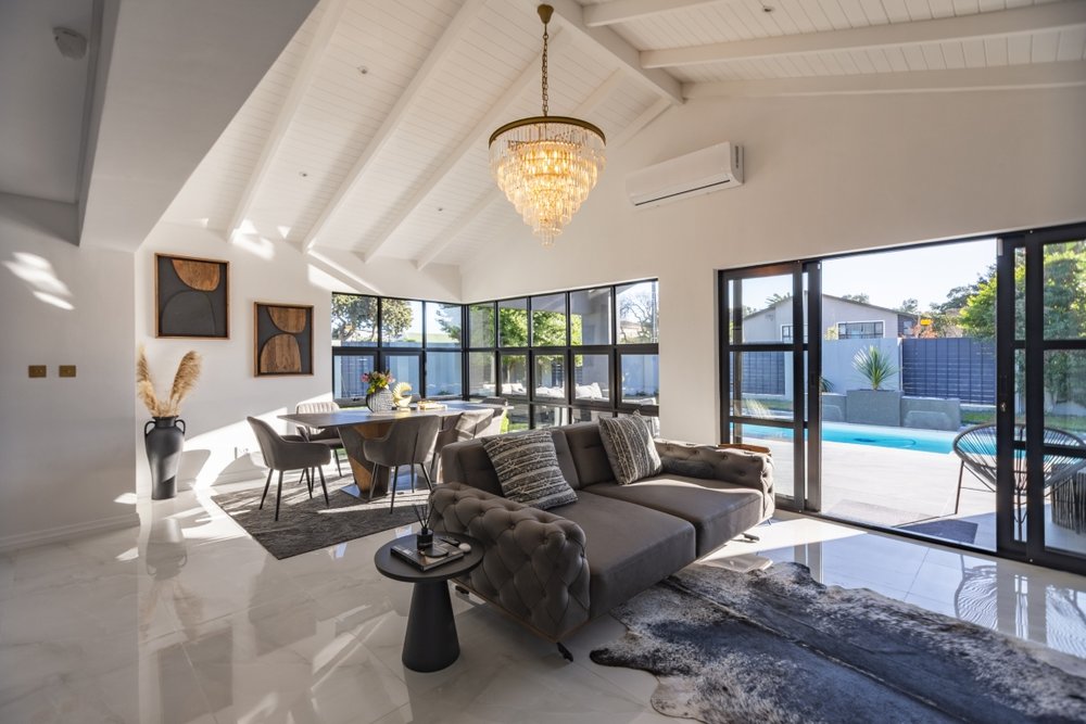 Open-plan living and dining area looking out to the pool