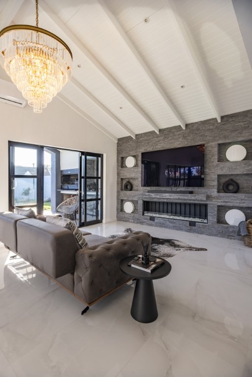 Living room with a stacked-stone feature wall and fireplace