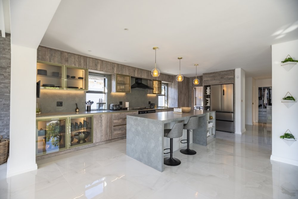 Kitchen with warm wood-tone cabinetry and brass pendant lights