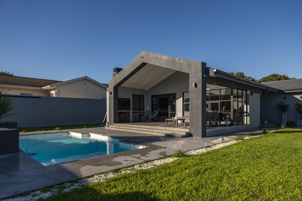 Pool and covered outdoor living area, wide view
