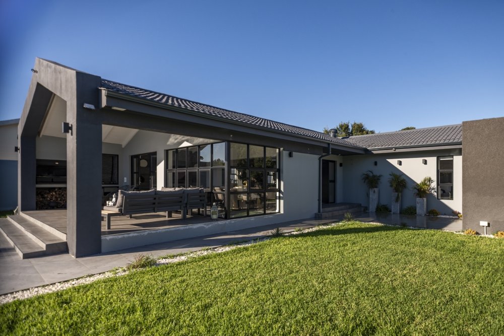 Wide exterior view of the covered patio and front garden