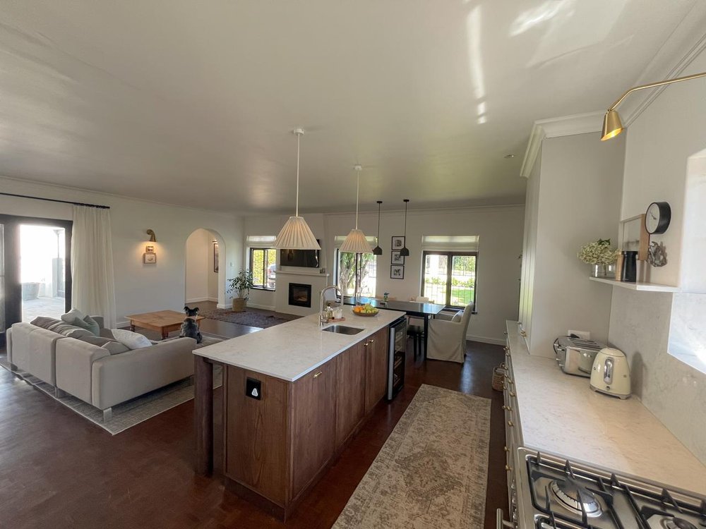 Kitchen with a timber island, overlooking the living area