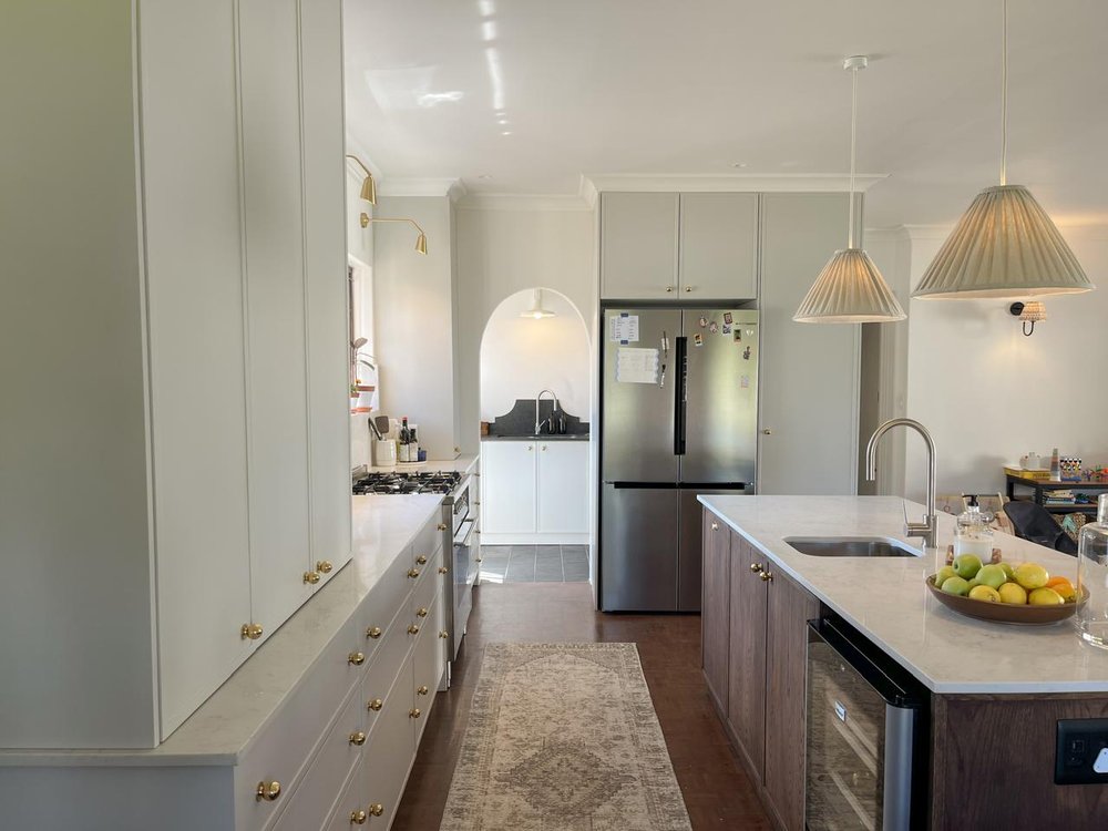 Long kitchen view with an arched nook and freestanding cooker