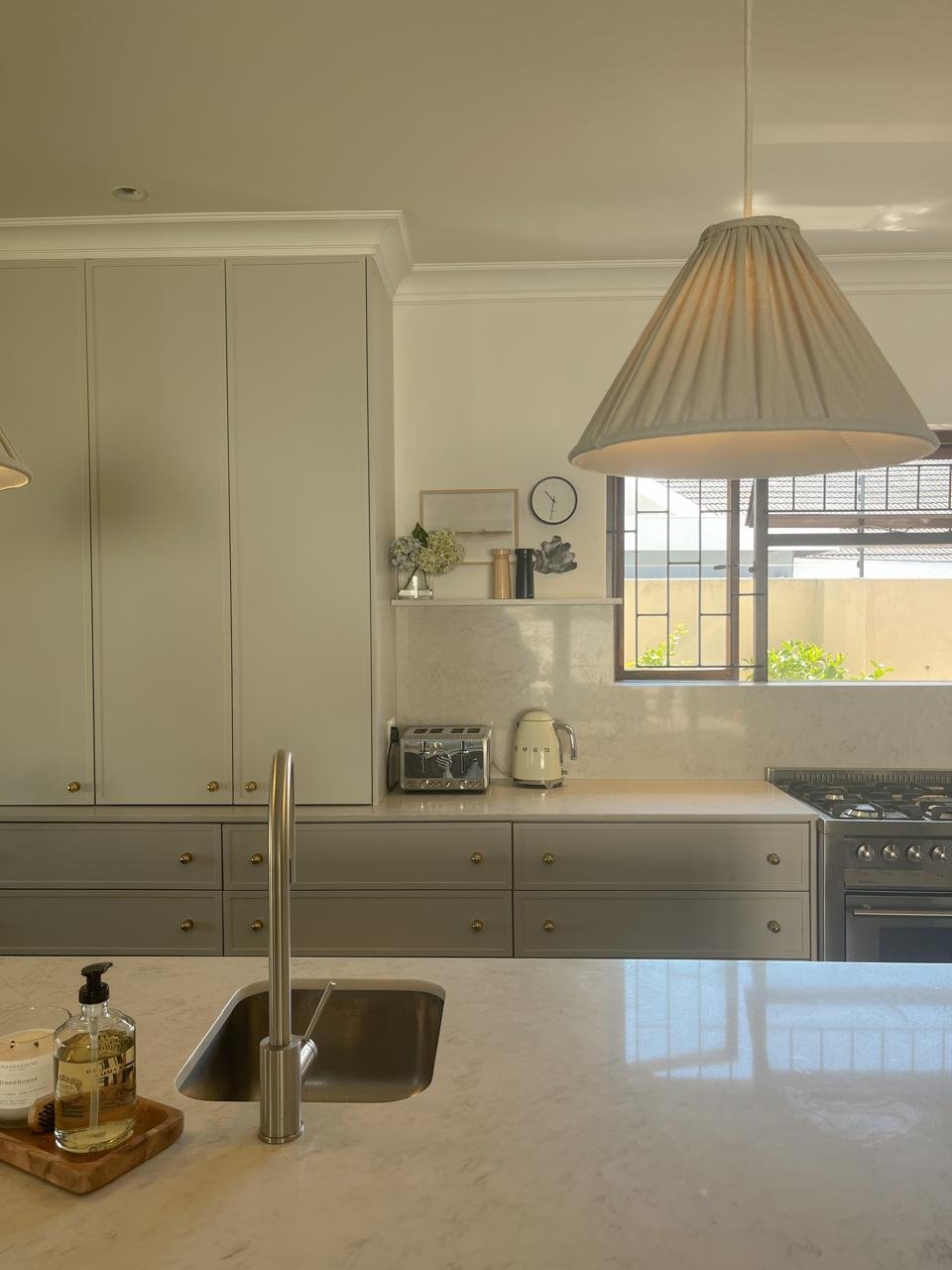 Kitchen counter detail with pendant light and gas range